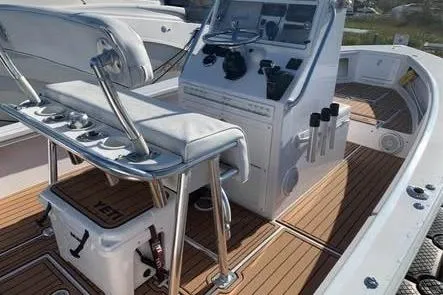 Slide: The Image of 2010 SeaCraft 20 SF boat interior with helm, seating, and wooden deck. - 6