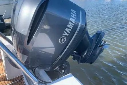 Slide: The Image of Yamaha outboard motor on 2010 SeaCraft 20 SF boat, docked on calm water. - 7