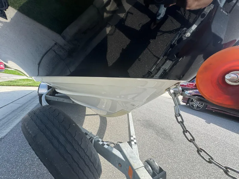 Slide: The Image of 2018 Yamaha Boats 212X on trailer, close-up of hull and wheel. - 18