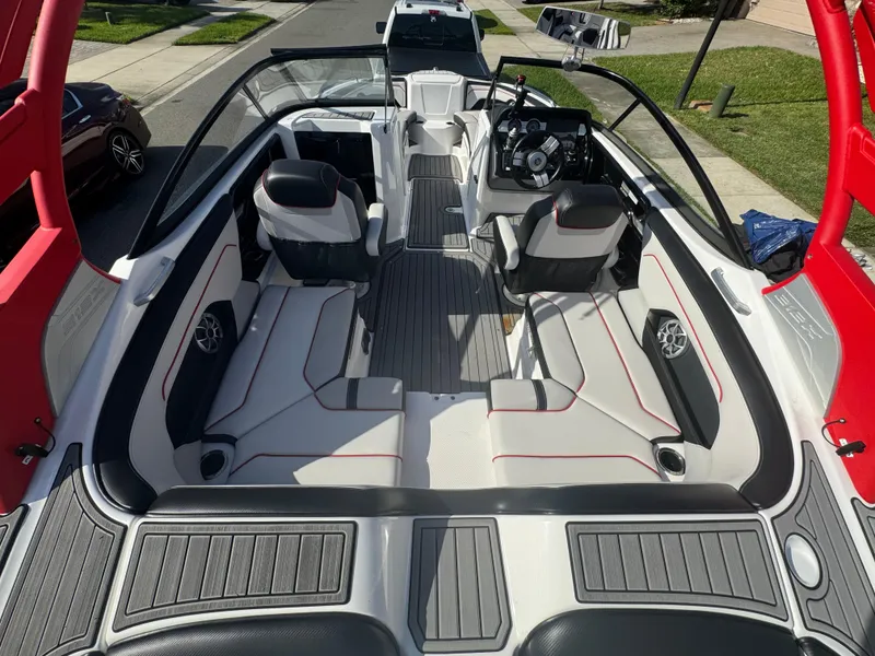 Slide: The Image of 2018 Yamaha Boats 212X interior with sleek seating and modern dashboard design. - 23