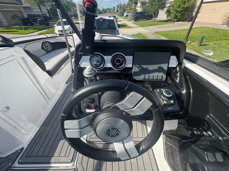 Slide: The Image of 2018 Yamaha Boats 212X dashboard with steering wheel and control panel. - 28