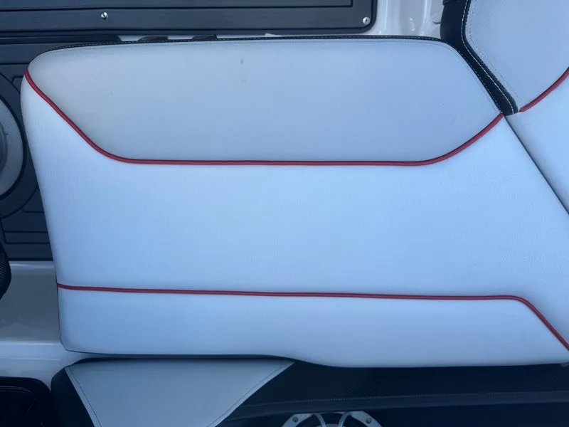 Slide: The Image of 2018 Yamaha Boats 212X interior detail with white upholstery and red accents. - 32