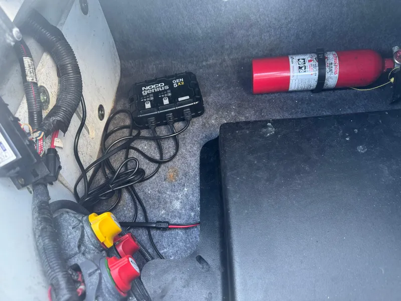 Slide: The Image of 2018 Yamaha Boats 212X interior with NOCO Genius charger and fire extinguisher. - 33