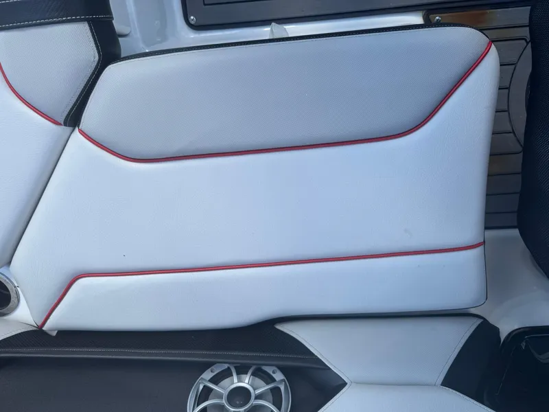 Slide: The Image of 2018 Yamaha Boats 212X interior with white and red-accented seating. - 34