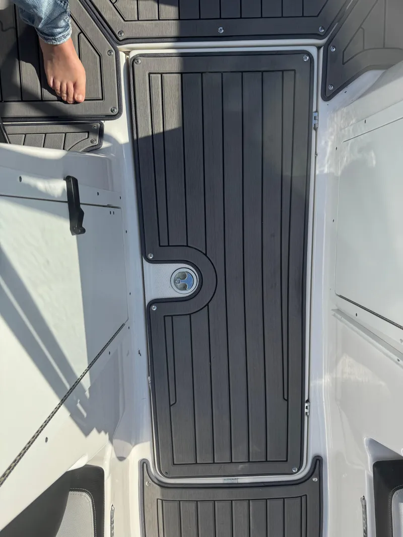 Slide: The Image of 2018 Yamaha Boats 212X deck with sleek black flooring. - 42