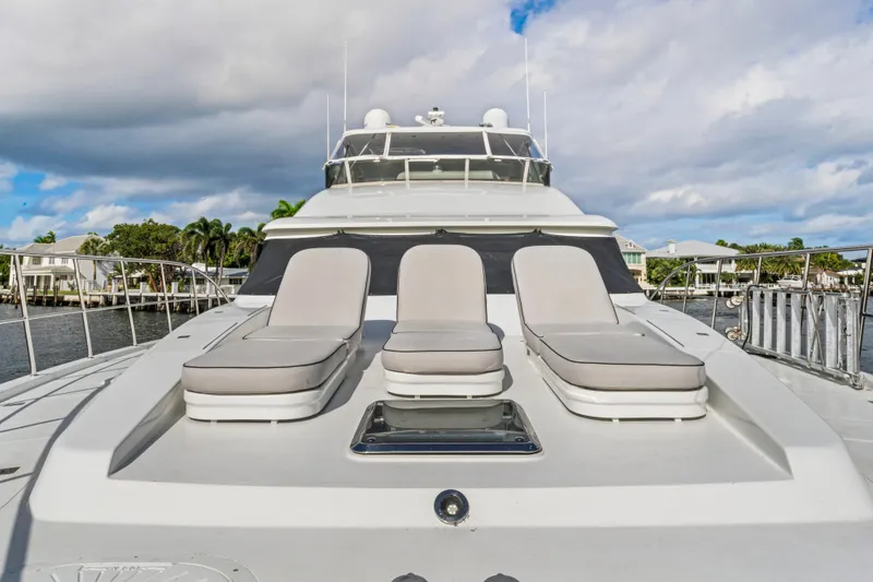 Slide: The Image of 2006 Cheoy Lee 84 Bravo yacht with sun loungers on deck, under a partly cloudy sky. - 16