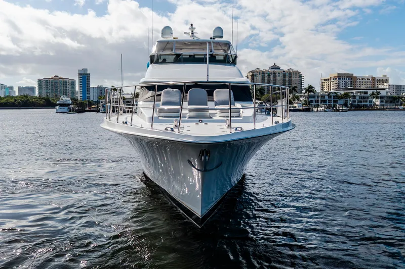 Slide: The Image of Front view of 2006 Cheoy Lee 84 Bravo yacht on water, with city skyline backdrop. - 2