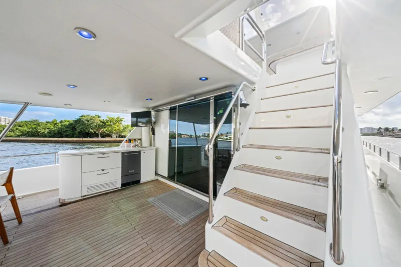 Slide: The Image of Luxury deck of 2006 Cheoy Lee 84 Bravo yacht with dining area and American flag. - 22