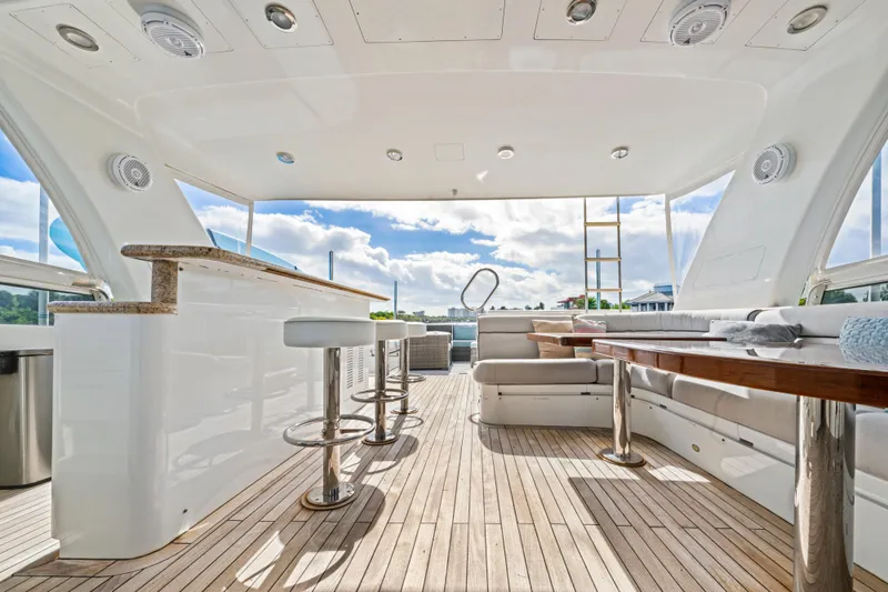 Slide: The Image of Luxurious 2006 Cheoy Lee 84 Bravo yacht interior with bar, seating, and elegant wood finishes. - 30