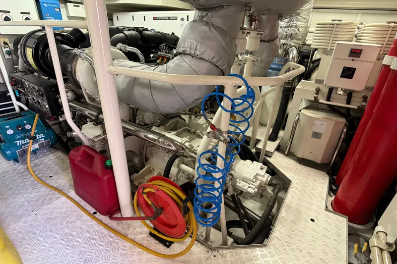 Slide: The Image of Engine room of 2006 Cheoy Lee 84 Bravo yacht with electrical equipment and fire extinguisher. - 58