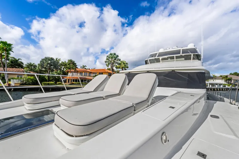 Slide: The Image of Luxury 2006 Cheoy Lee 84 Bravo yacht with sun loungers on deck, cruising a scenic waterway. - 17