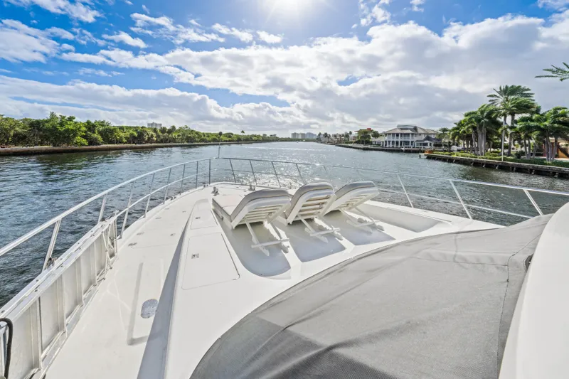Slide: The Image of Luxurious 2006 Cheoy Lee 84 Bravo yacht with sun loungers, docked by palm trees. - 19