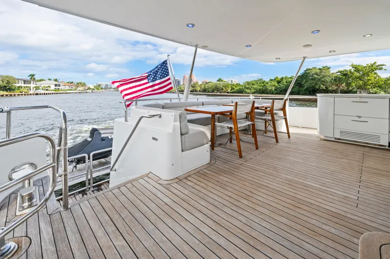 Slide: The Image of Spacious deck of 2006 Cheoy Lee 84 Bravo yacht with seating and American flag. - 23