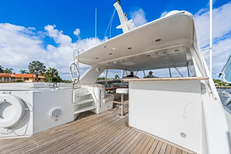 Slide: The Image of Luxurious 2006 Cheoy Lee 84 Bravo yacht deck with seating and jacuzzi under blue sky. - 26