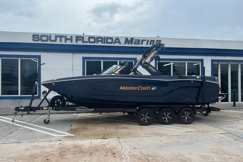 The Image of 2026 MasterCraft XT24 boat on trailer at South Florida Marine dealership. - 0