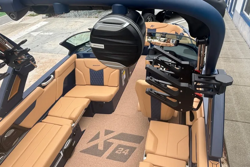 Slide: The Image of 2026 MasterCraft XT24 boat interior with tan seating and advanced audio system. - 4
