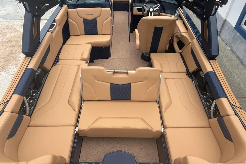 Slide: The Image of 2026 MasterCraft XT24 boat interior with tan and navy seating, spacious layout, and modern design. - 7
