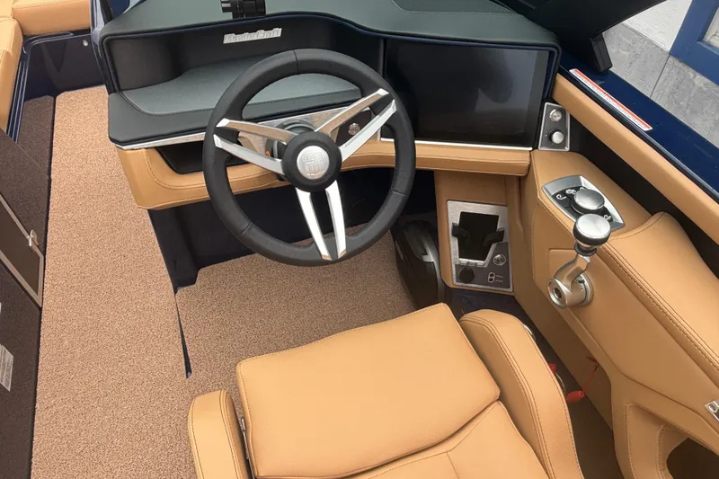 Slide: The Image of 2026 MasterCraft XT24 boat interior with tan leather seats and modern steering console. - 9