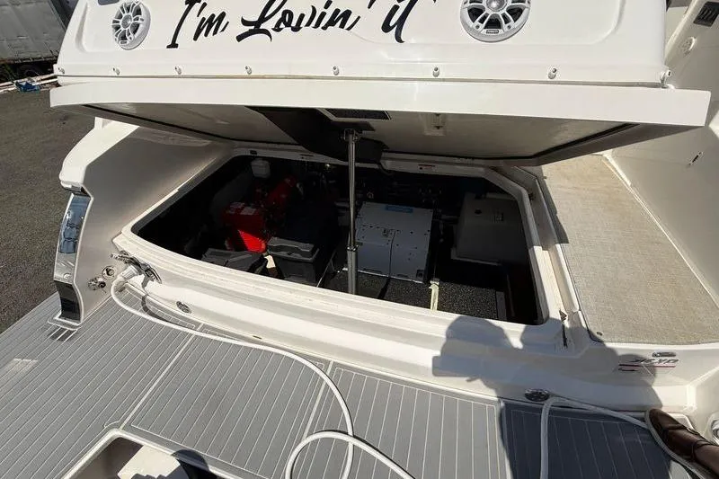 Slide: The Image of 2022 Regal 36 XO yacht engine compartment with open hatch, showcasing interior components. - 10