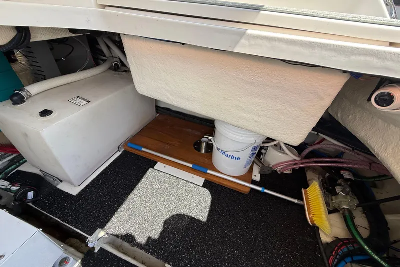 Slide: The Image of 2022 Regal 36 XO boat interior storage area with equipment and cleaning supplies. - 13