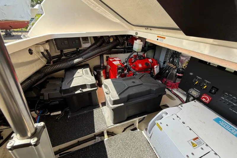 Slide: The Image of Engine compartment of 2022 Regal 36 XO boat, showcasing batteries and electrical components. - 14