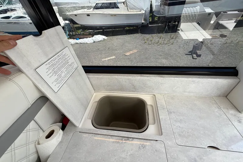 Slide: The Image of 2022 Regal 36 XO yacht interior with open storage compartment and window view. - 29