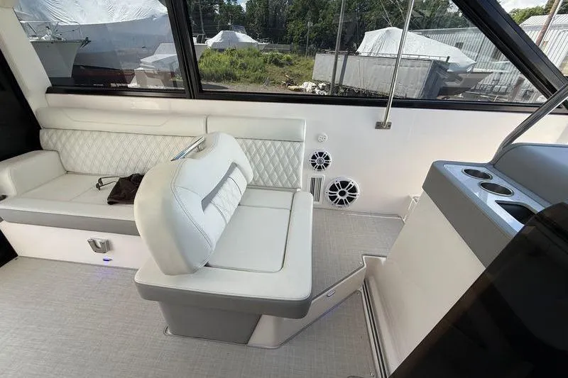 Slide: The Image of Interior of 2022 Regal 36 XO yacht with white seating and cup holders. - 35