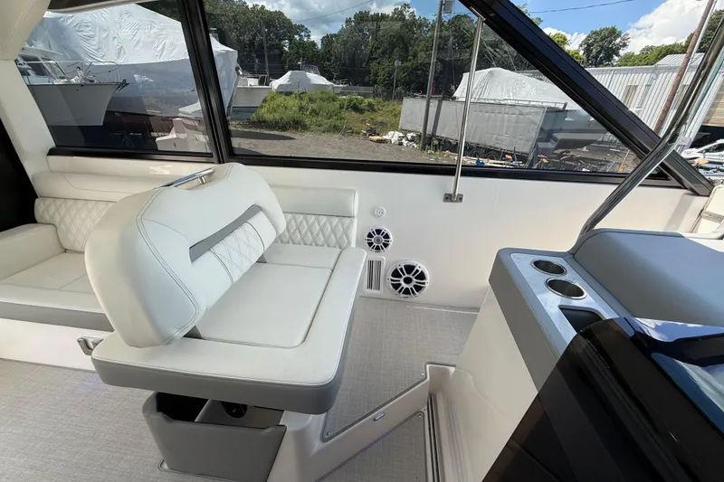 Slide: The Image of Interior of 2022 Regal 36 XO yacht with white seating and modern design. - 36