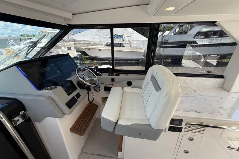 Slide: The Image of 2022 Regal 36 XO yacht cockpit with modern helm and luxurious seating. - 37