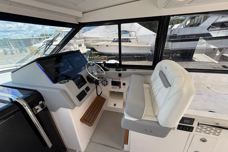 Slide: The Image of Interior of 2022 Regal 36 XO boat with modern helm and luxurious seating. - 38