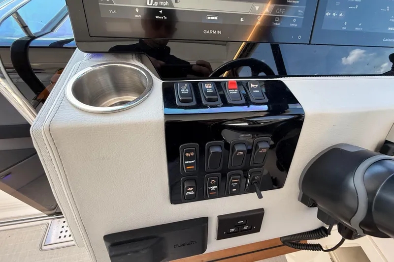 Slide: The Image of Control panel of 2022 Regal 36 XO boat with Garmin display and cup holder. - 39