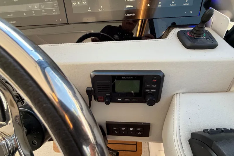 Slide: The Image of 2022 Regal 36 XO boat dashboard with Garmin navigation system and controls. - 40