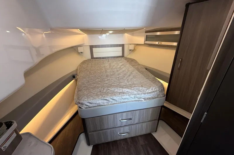 Slide: The Image of 2022 Regal 36 XO cabin interior with bed and storage drawers. - 48