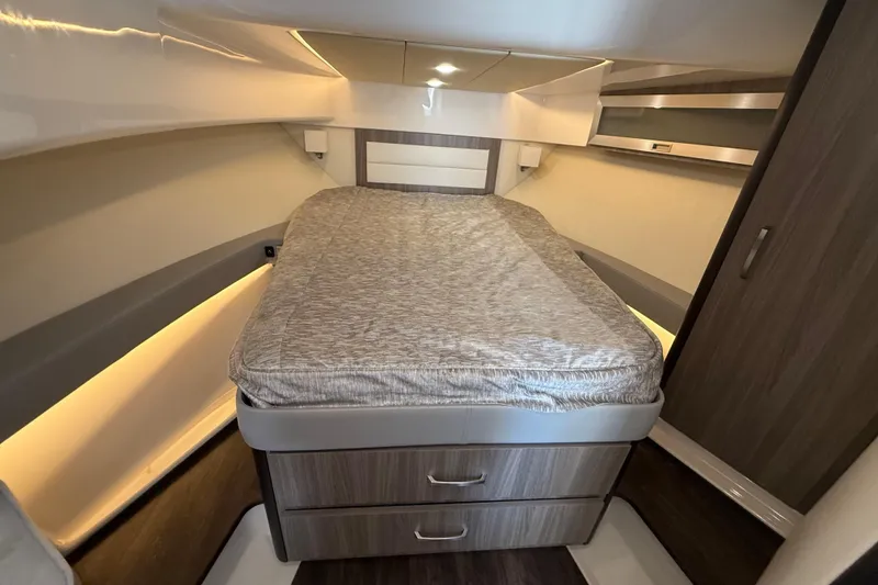 Slide: The Image of 2022 Regal 36 XO cabin interior with bed and storage drawers. - 49