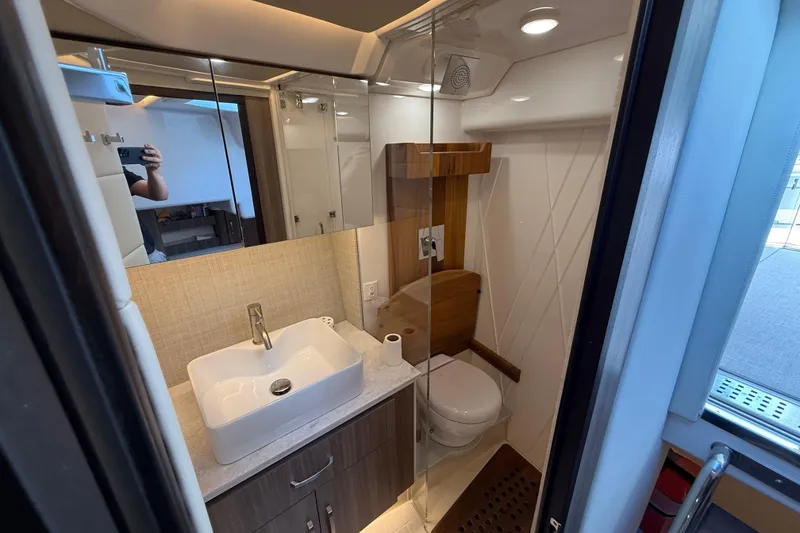 Slide: The Image of Modern bathroom in 2022 Regal 36 XO yacht with sleek sink and shower. - 55
