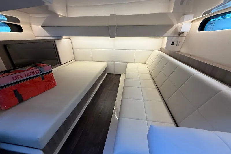 Slide: The Image of Interior of 2022 Regal 36 XO yacht with white seating and life jackets. - 57