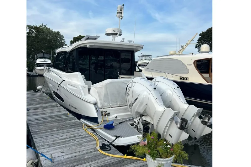 Slide: The Image of 2022 Regal 36 XO boat docked with dual Yamaha outboard engines. - 62