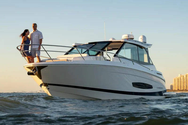 Slide: The Image of Manufacturer Provided Image: 2022 Regal 36 XO boat cruising with a couple on deck. - 69