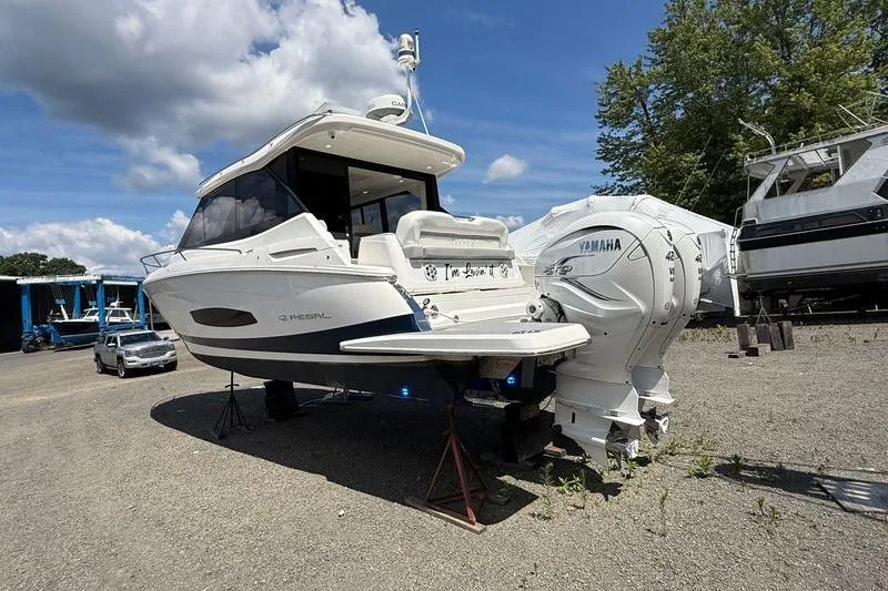 Slide: The Image of 2022 Regal 36 XO boat with Yamaha engines on a sunny day. - 8