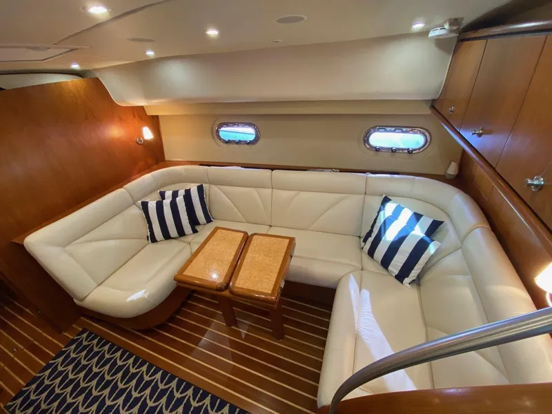 Slide: The Image of Interior of 2009 Tiara Yachts 4300 Sovran with leather sofa and wooden table. - 18