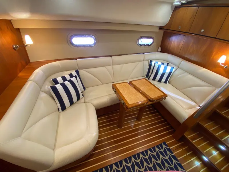 Slide: The Image of Interior of 2009 Tiara Yachts 4300 Sovran with leather sofa and wooden table. - 19