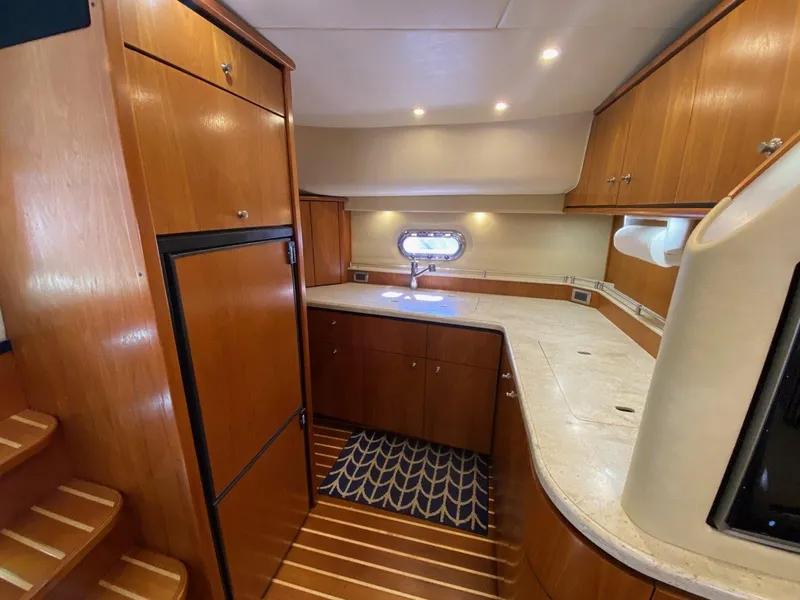 Slide: The Image of Interior of 2009 Tiara Yachts 4300 Sovran with wood cabinetry and kitchenette. - 21