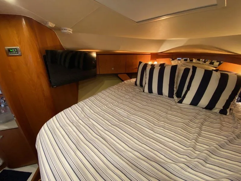 Slide: The Image of Interior of 2009 Tiara Yachts 4300 Sovran with cozy bed and TV. - 26