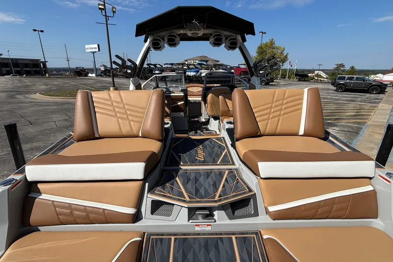 Slide: The Image of 2025 Tigé Ultré 25ZX boat interior with tan seating and modern design. - 10