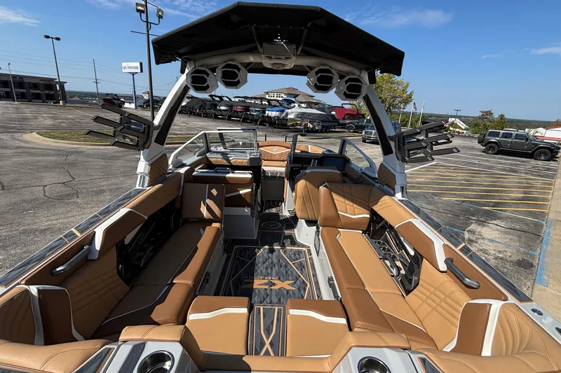 Slide: The Image of 2025 Tigé Ultré 25ZX boat interior with tan seating and modern design. - 11