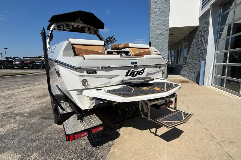 Slide: The Image of 2025 Tigé Ultré 25ZX boat with sleek design and modern features, parked outdoors. - 4