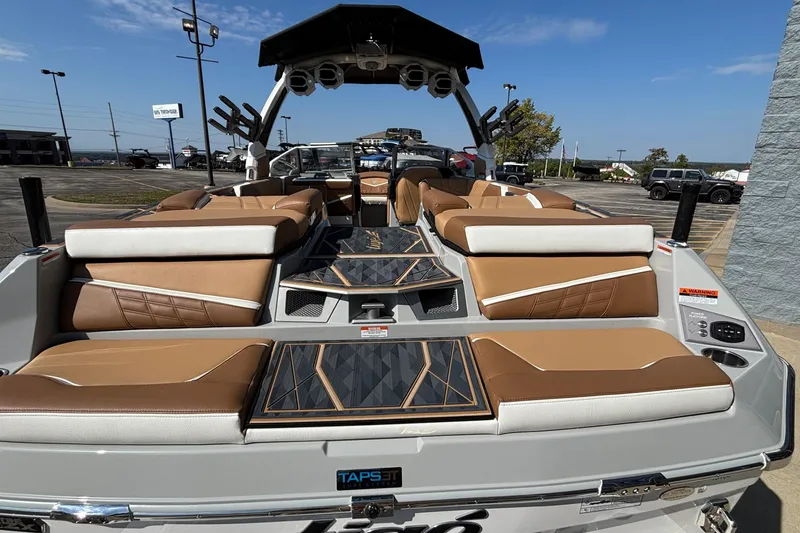 Slide: The Image of 2025 Tigé Ultré 25ZX boat interior with tan and white seating, modern design, and TAPS 3T technology. - 9