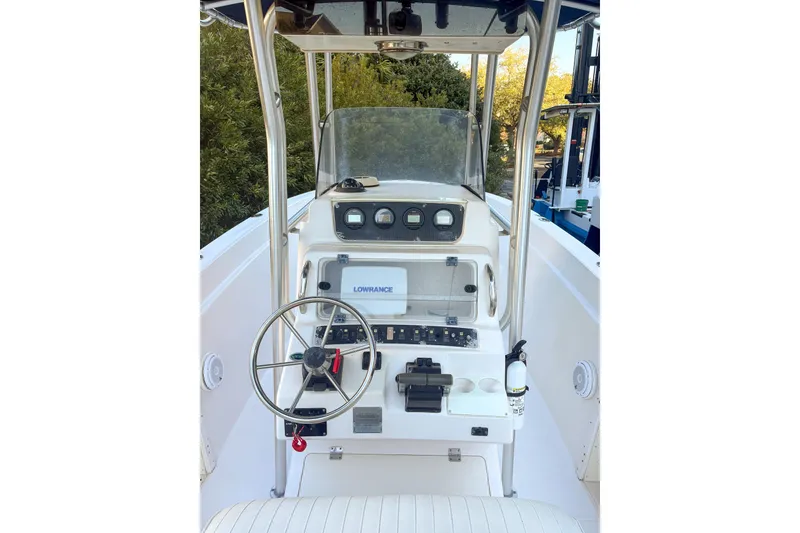 Slide: The Image of 2001 Grady-White Chase 263 boat console with steering wheel and navigation equipment. - 11