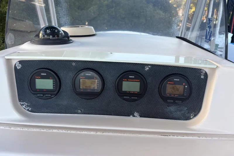 Slide: The Image of Dashboard of 2001 Grady-White Chase 263 boat with Yamaha gauges and compass. - 13