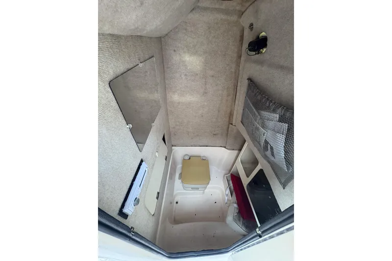 Slide: The Image of 2001 Grady-White Chase 263 cabin interior with storage compartments and seating. - 14